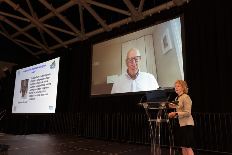 Stephen Buchner accepting the 2026 Radiation Effects Award by video at NSREC 2026 in San Juan, presented by RESG Executive Chair Kay Chesnut